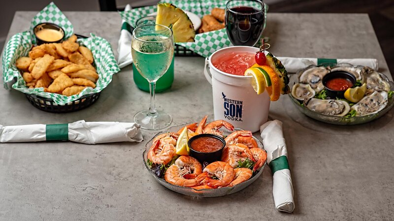 Multiple cocktails and appetizers with focus on peel & eat shrimp